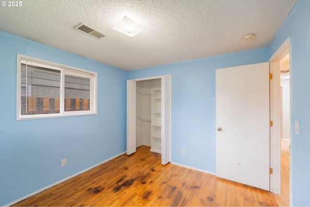 446 44th Ave, Salem, OR 97317 - unfurnished bedroom with wood finished floors, a textured ceiling, a closet, and baseboards