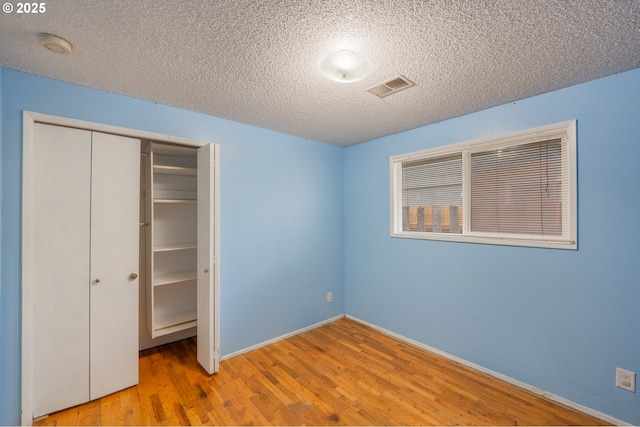 446 44th Ave, Salem, OR 97317 - unfurnished bedroom with a closet, a textured ceiling, wood finished floors, and baseboards