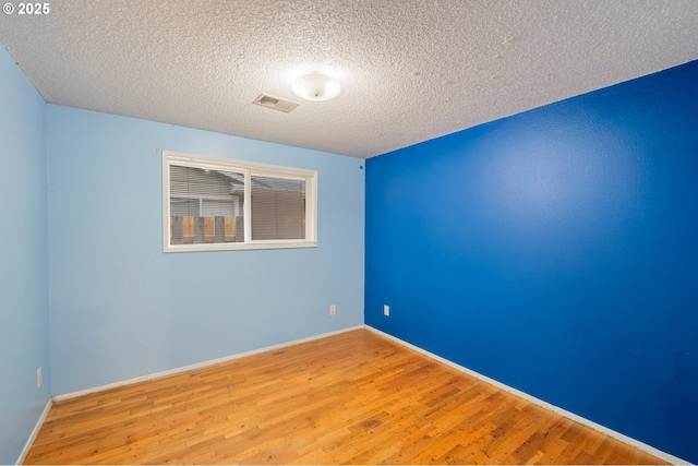 446 44th Ave, Salem, OR 97317 - empty room with wood finished floors, a textured ceiling, and baseboards