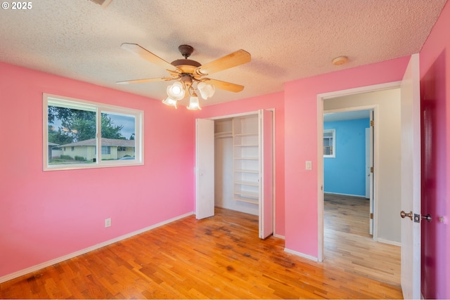 446 44th Ave, Salem, OR 97317 - unfurnished bedroom featuring light wood-type flooring, a closet, a textured ceiling, ceiling fan, and baseboards