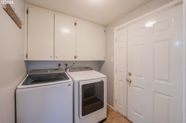 446 44th Ave, Salem, OR 97317 - laundry room with washer and clothes dryer, cabinet space, and a textured ceiling