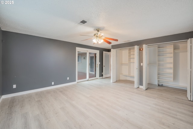 446 44th Ave, Salem, OR 97317 - unfurnished bedroom featuring light wood finished floors, a textured ceiling, two closets, baseboards, and a ceiling fan