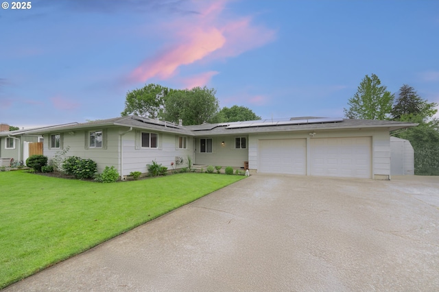 446 44th Ave, Salem, OR 97317 - single story home with an attached garage, concrete driveway, a front lawn, and solar panels