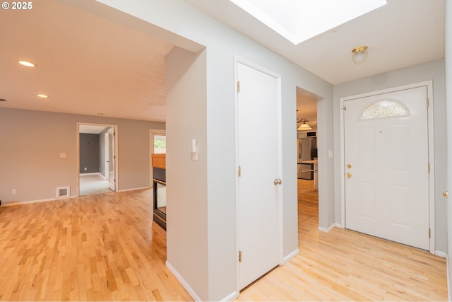 446 44th Ave, Salem, OR 97317 - foyer entrance featuring light wood finished floors, recessed lighting, baseboards, and a skylight
