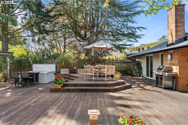 deck with fence, outdoor dining area, and a grill