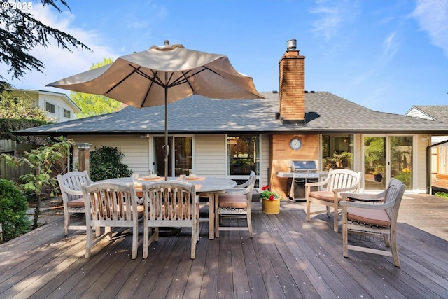 deck featuring outdoor dining area and a grill