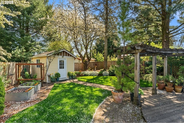 view of yard with a pergola, a fenced backyard, a shed, a vegetable garden, and an outbuilding