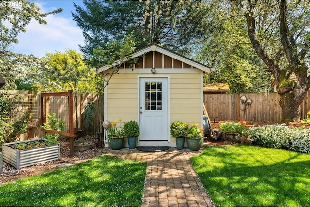 view of shed with a garden and a fenced backyard