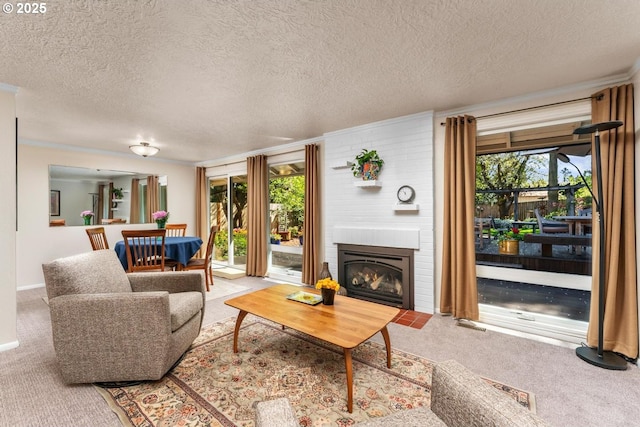 living area with carpet floors, a textured ceiling, and a large fireplace