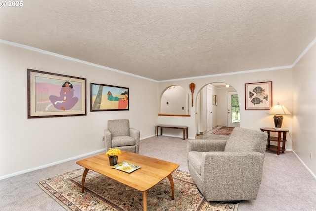 carpeted living room featuring crown molding, arched walkways, and baseboards