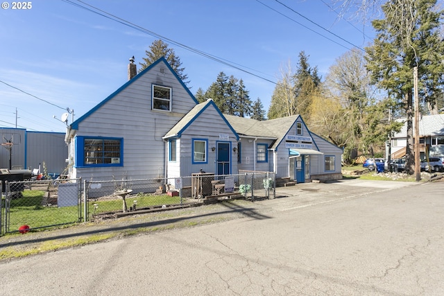 view of front of property featuring a fenced front yard and a chimney