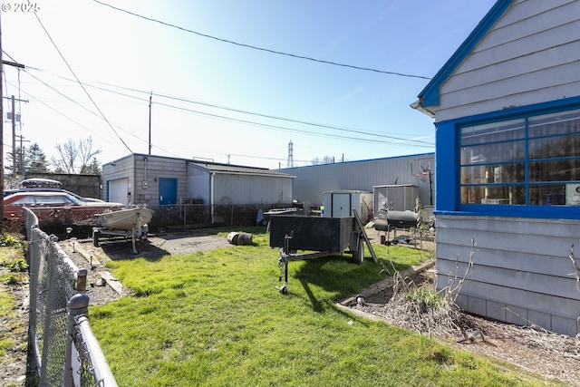 view of yard featuring a garage and fence