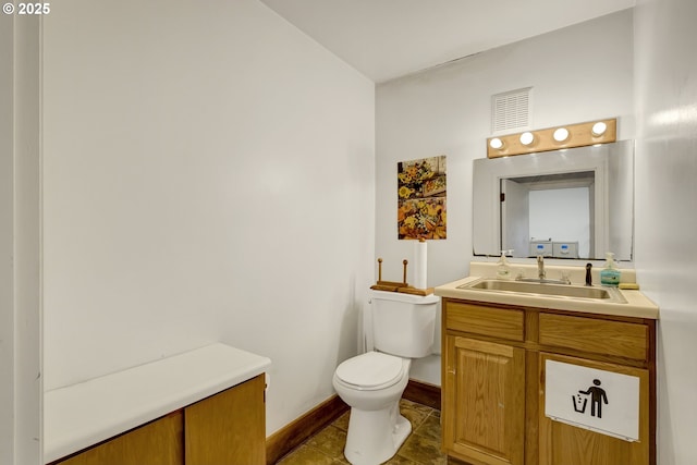 8935 SE Stanley Pl, Portland, OR 97206 - half bath with vanity, baseboards, visible vents, and toilet