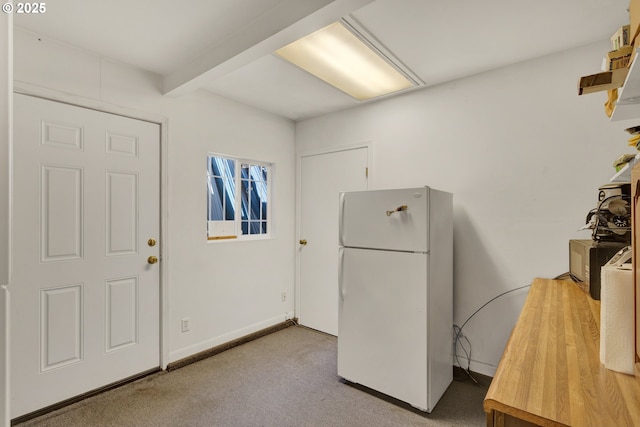 kitchen featuring baseboards, freestanding refrigerator, open shelves, beamed ceiling, and carpet