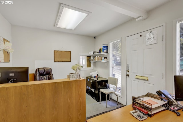 interior space with carpet and beam ceiling