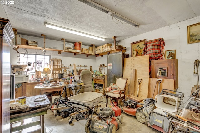 miscellaneous room with a workshop area and unfinished concrete floors