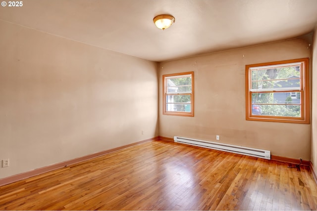 8935 SE Stanley Pl, Portland, OR 97206 - unfurnished room featuring baseboards, a baseboard heating unit, and light wood-style flooring