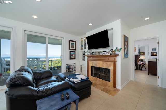 5952 SW Cupola Dr, South Beach, OR 97366 - living area featuring a tile fireplace, light tile patterned flooring, baseboards, and recessed lighting