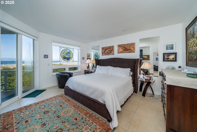 5952 SW Cupola Dr, South Beach, OR 97366 - bedroom with light tile patterned floors, baseboards, and access to exterior