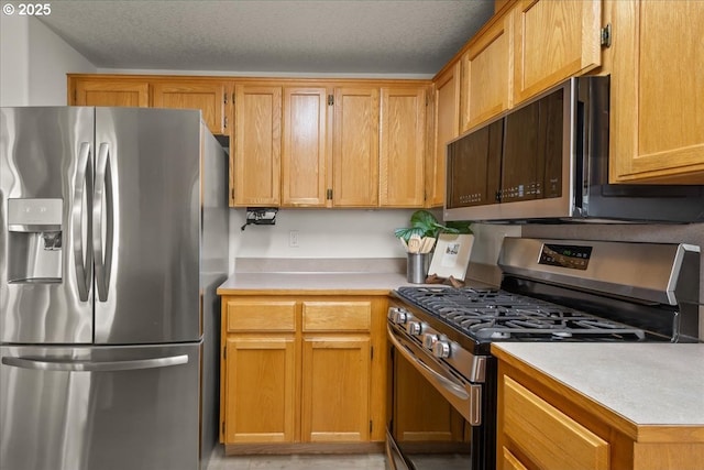 15314 NE 88th St, Vancouver, WA 98682 - kitchen with appliances with stainless steel finishes, light countertops, and a textured ceiling