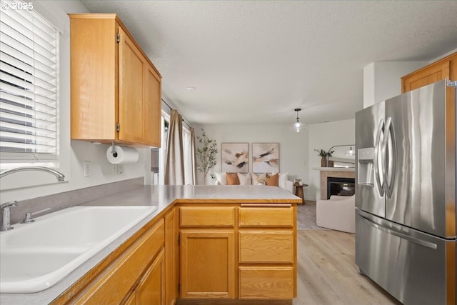 15314 NE 88th St, Vancouver, WA 98682 - kitchen with stainless steel fridge, a peninsula, plenty of natural light, and light wood-type flooring
