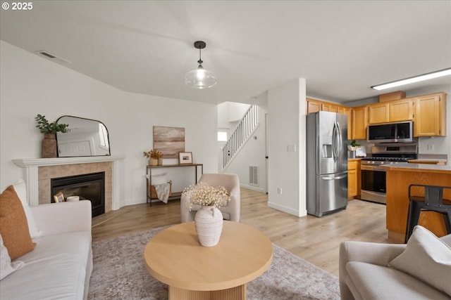 15314 NE 88th St, Vancouver, WA 98682 - living area featuring light wood-style flooring, stairs, and a fireplace