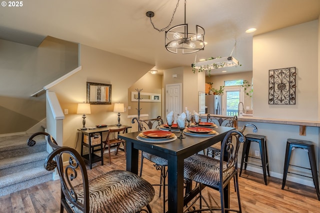 dining room featuring baseboards, stairway, wood finished floors, and recessed lighting