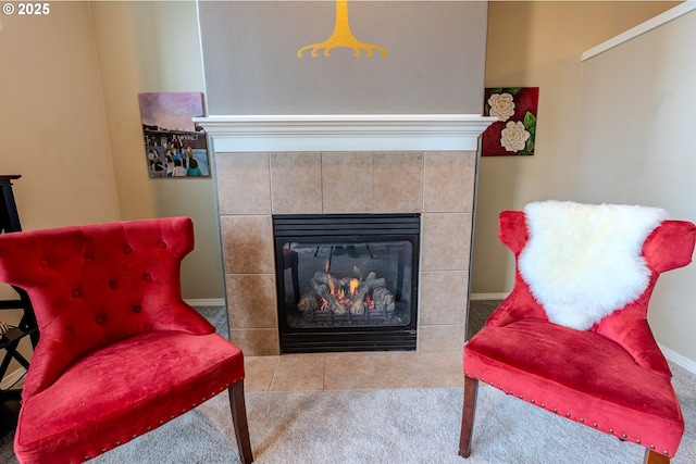 sitting room with carpet floors and a tiled fireplace