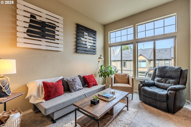 living area with carpet flooring and baseboards