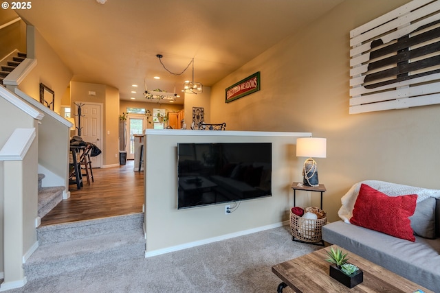 carpeted living room with recessed lighting, an inviting chandelier, baseboards, and stairs