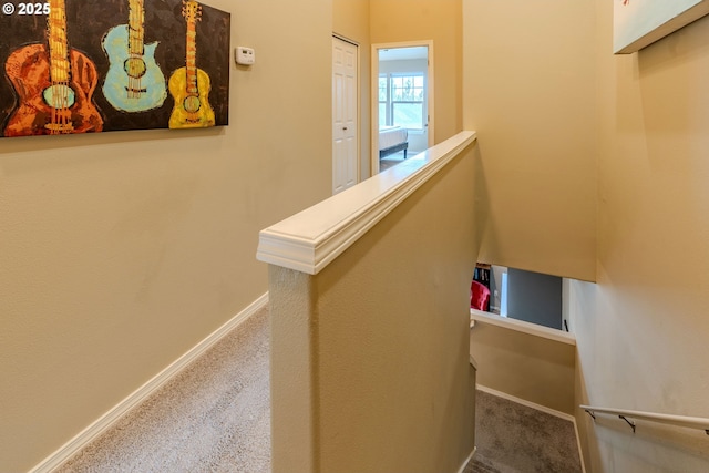 stairs featuring carpet floors and baseboards