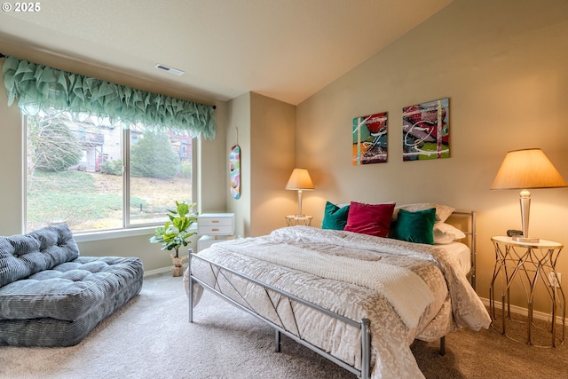 carpeted bedroom featuring lofted ceiling, visible vents, and baseboards