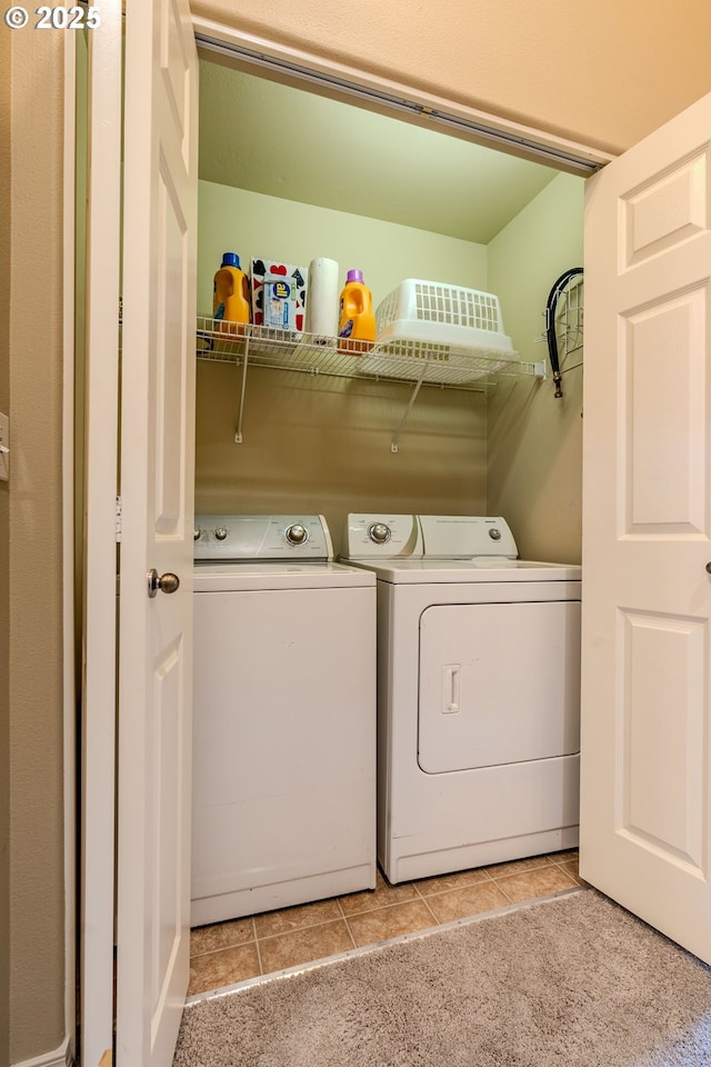 laundry room with washer and dryer, laundry area, light colored carpet, and light tile patterned floors