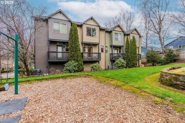 view of front of home with a front lawn and central AC unit