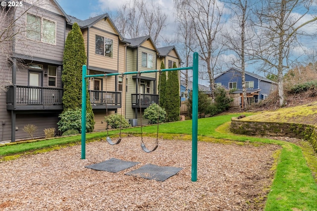 community play area with a residential view and a lawn