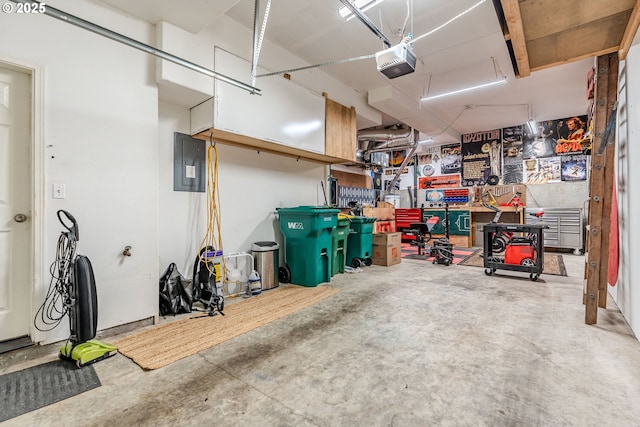 garage featuring a workshop area, electric panel, and a garage door opener