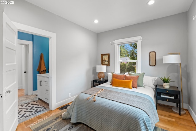 bedroom featuring light wood-style floors, recessed lighting, and baseboards