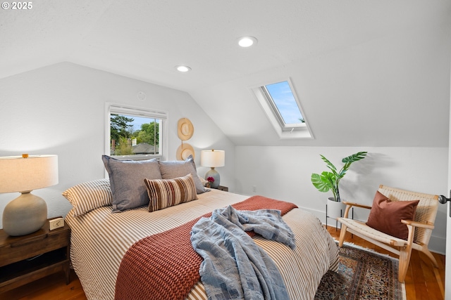 bedroom featuring lofted ceiling, a skylight, wood finished floors, and recessed lighting