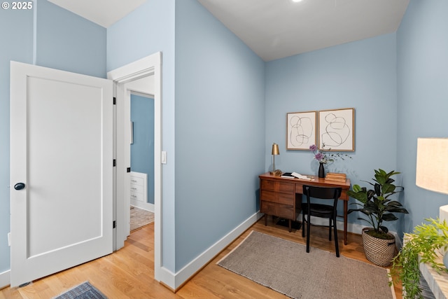 office with light wood-style flooring and baseboards
