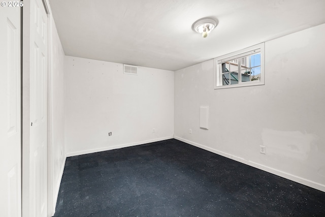 unfurnished bedroom with baseboards and dark floors