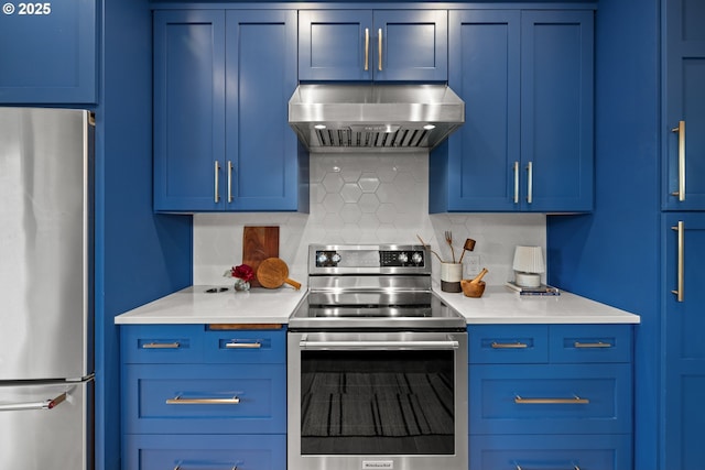 kitchen featuring appliances with stainless steel finishes, ventilation hood, blue cabinetry, and tasteful backsplash
