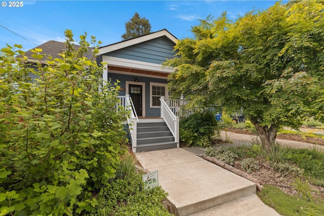 view of front of home with covered porch and stairs