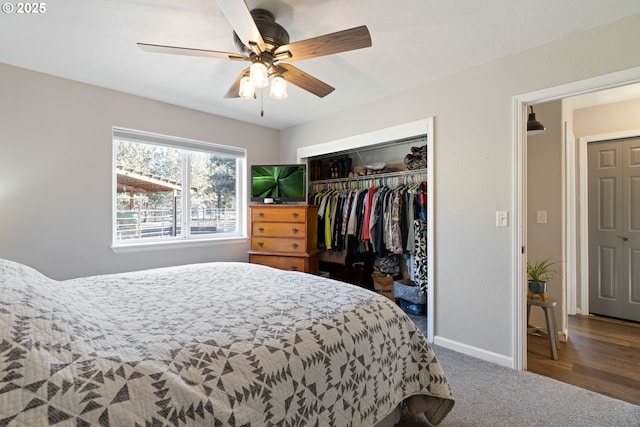 carpeted bedroom featuring a closet, ceiling fan, and baseboards