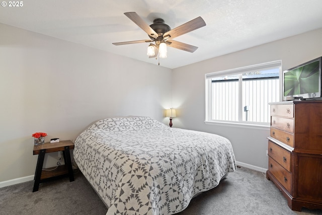 carpeted bedroom featuring a ceiling fan and baseboards