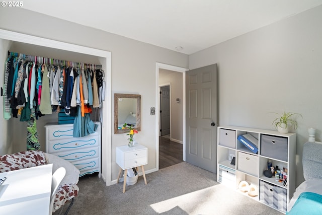 bedroom with carpet floors, a closet, and baseboards