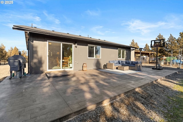 back of house featuring a patio area and an outdoor living space