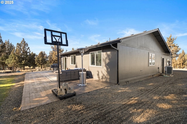 rear view of property with crawl space, a patio area, and central AC unit