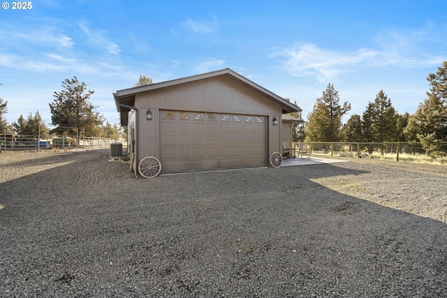 detached garage with fence and central air condition unit