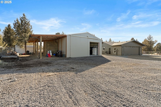 view of pole building featuring fence