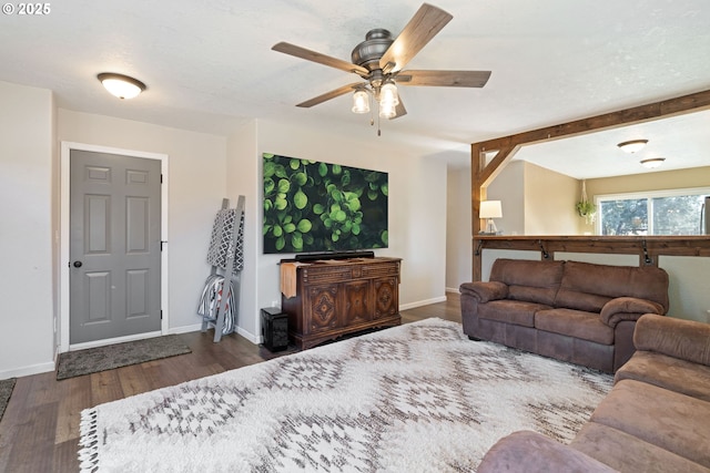 living room featuring ceiling fan, wood finished floors, and baseboards